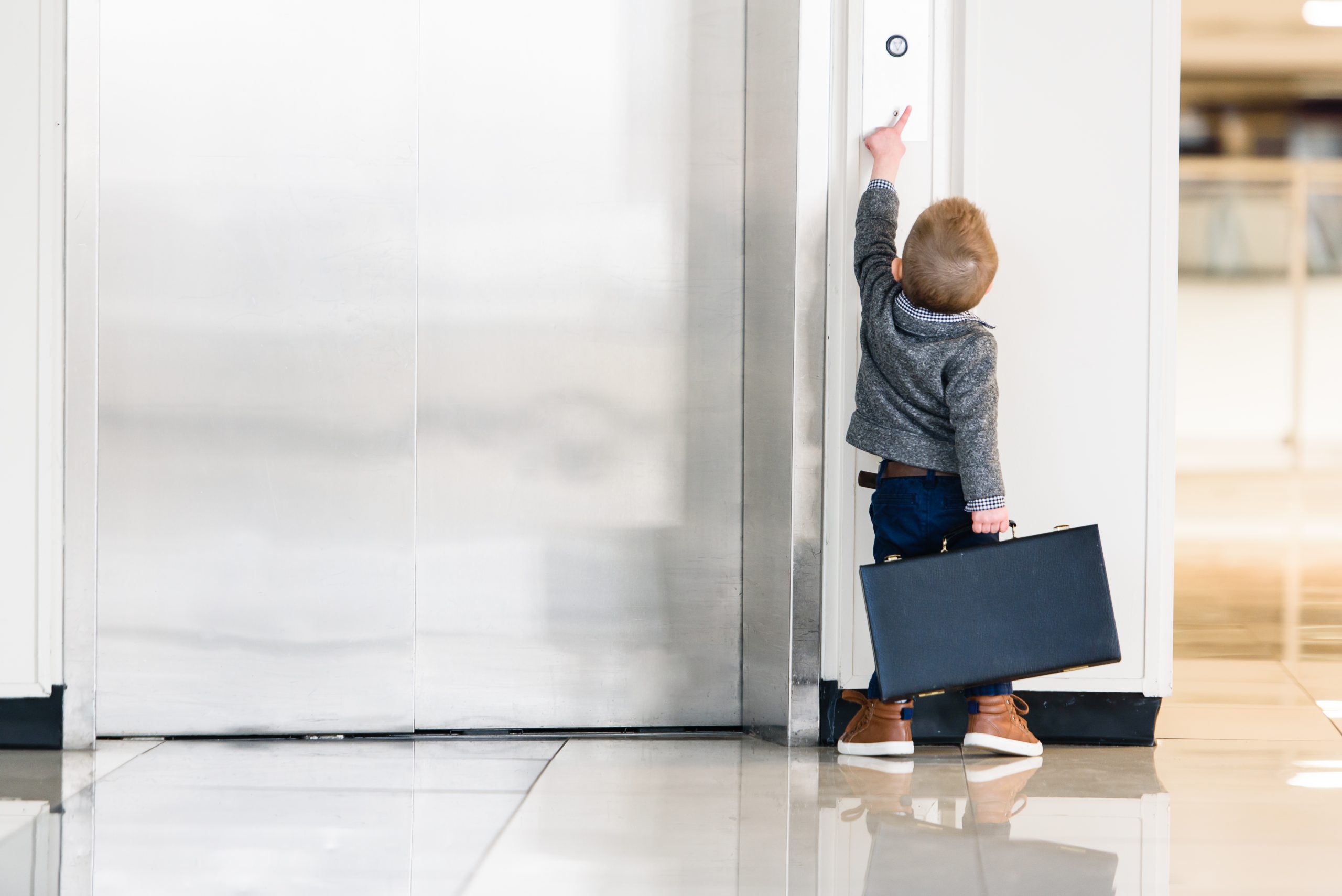 Child reaching for elevator